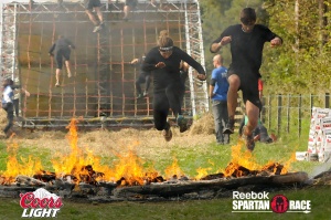 Jumping over the fire at the Spartan race 